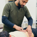 Dr.Usman assesing back pain patient